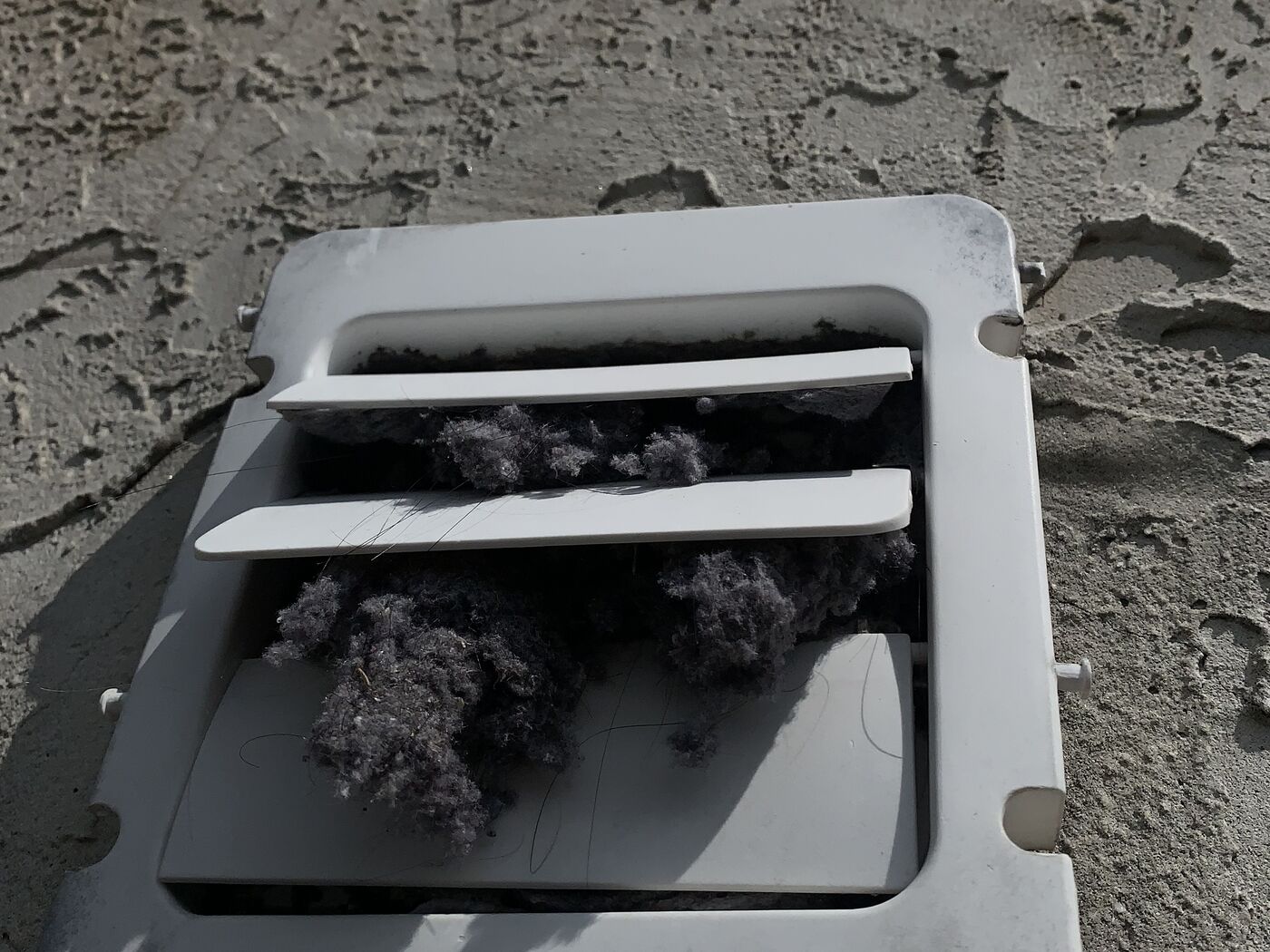 Dryer vent duct in a Powell home packed with a thick ring of lint before cleaning