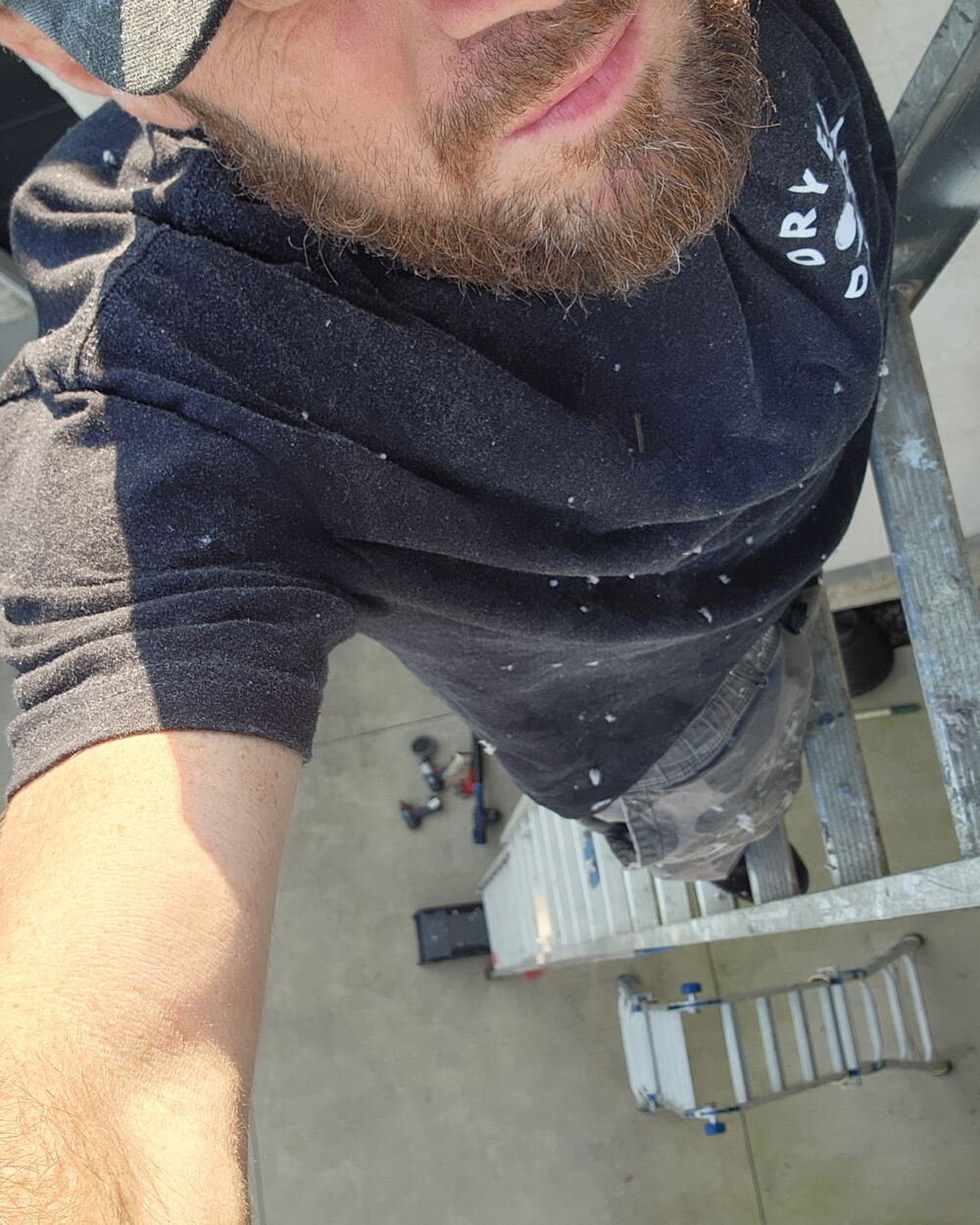 A Dryer Daddy technician on a ladder at a Central Ohio job site